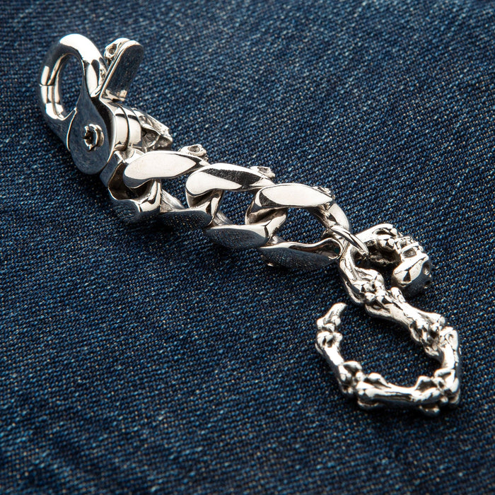 Rear view of the mad skull keychain showing the smooth, solid silver construction and weight.