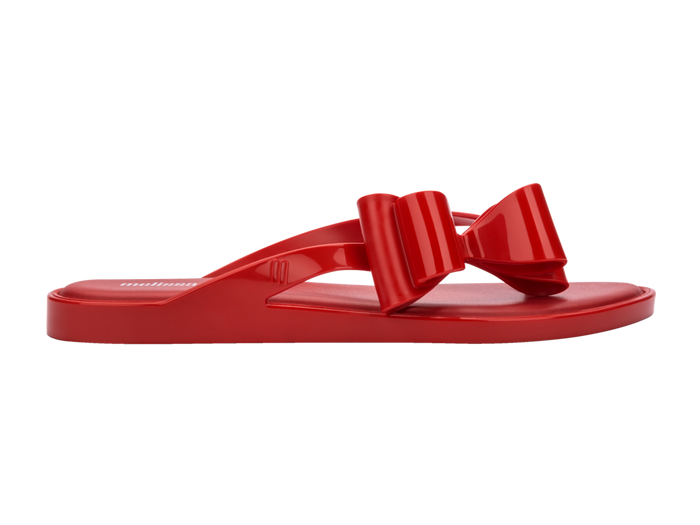 Melissa Flip Flop in red with a cute flat bow design, stylish and comfortable slip-on footwear for women.