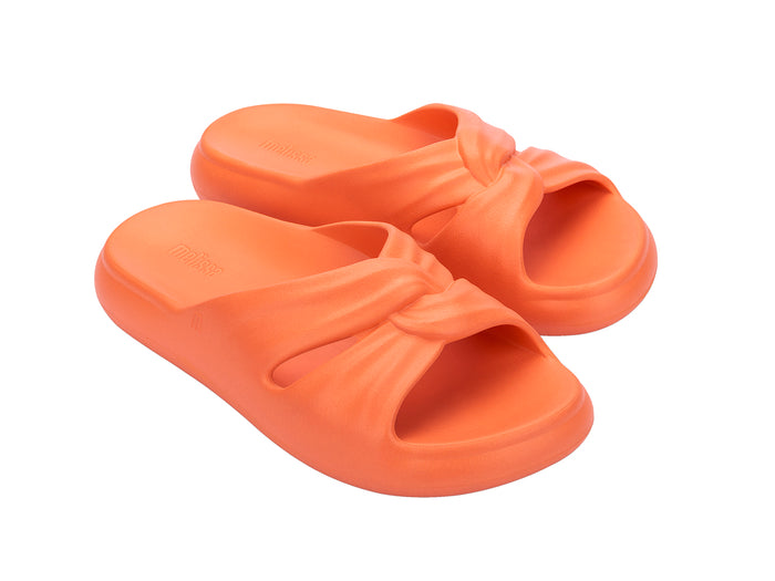 Melissa Free orange beach wear slide for women featuring a sleek design and lightweight comfort, perfect for casual summer outings and beach days.