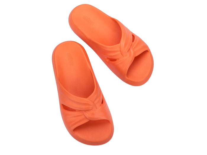 Melissa Free orange beach wear slide for women featuring a sleek design and lightweight comfort, perfect for casual summer outings and beach days.