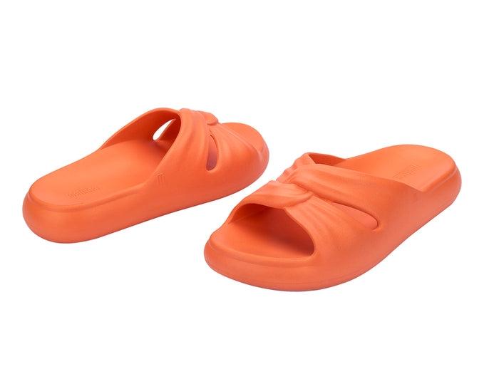 Melissa Free orange beach wear slide for women featuring a sleek design and lightweight comfort, perfect for casual summer outings and beach days.