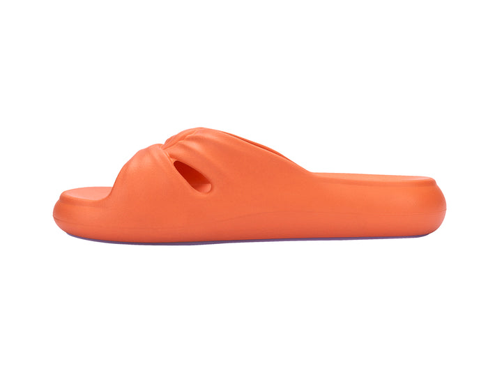 Melissa Free orange beach wear slide for women featuring a sleek design and lightweight comfort, perfect for casual summer outings and beach days.