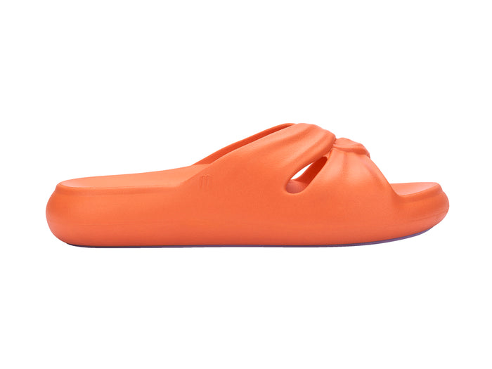Melissa Free orange beach wear slide for women featuring a sleek design and lightweight comfort, perfect for casual summer outings and beach days.