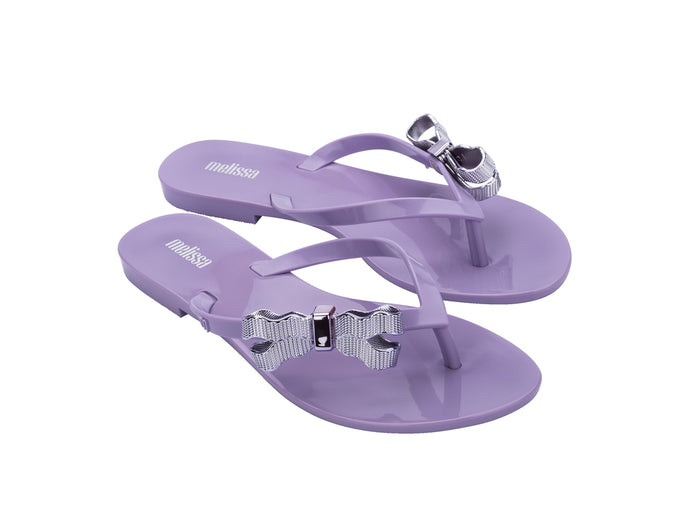 Melissa Harmonic Sweet V Flat Flip Flops Lilac Slippers for Women â€“ Stylish and comfortable flat flip-flops with a chic bow detail, perfect for casual and everyday wear.