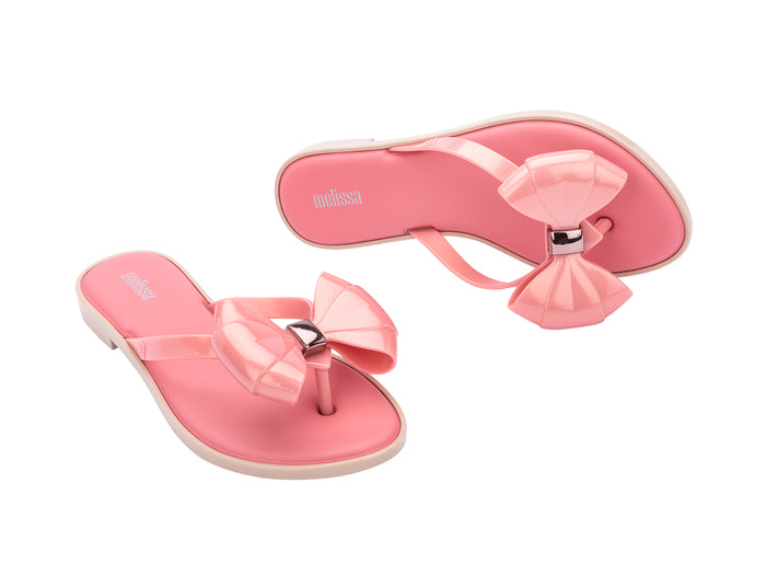 Melissa Slim flat pink flip flop with bow for women – stylish lightweight summer slipper offering comfort and feminine casual beachwear style