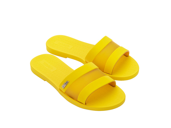 Melissa Sun Gaspea Ou Tiras yellow slides for women – trendy slip-on vegan sandals in bright summer style, crafted from Melflex for comfort and durability.