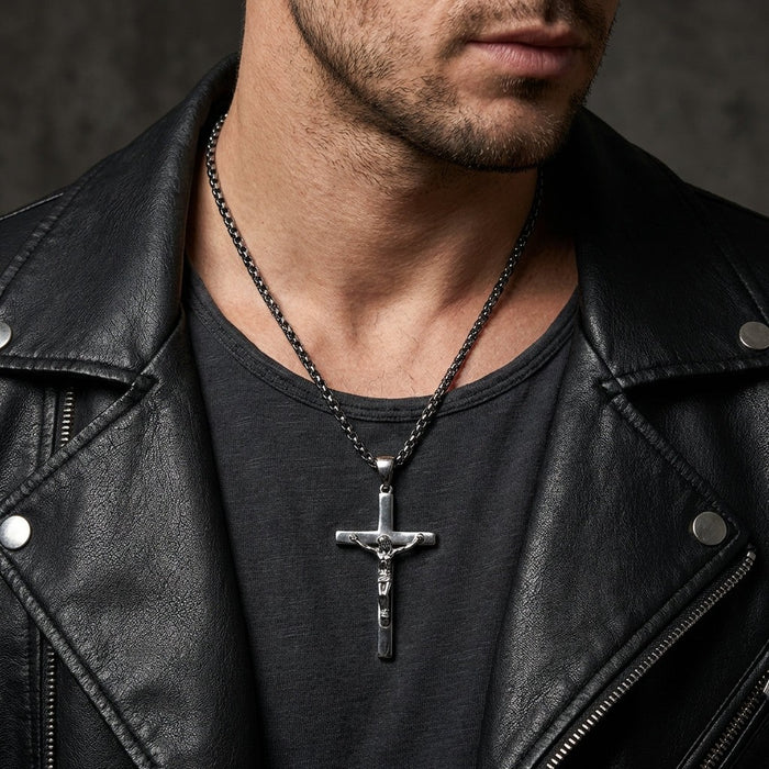 Man wearing sterling silver crucifix pendant necklace with black leather jacket and dark chain