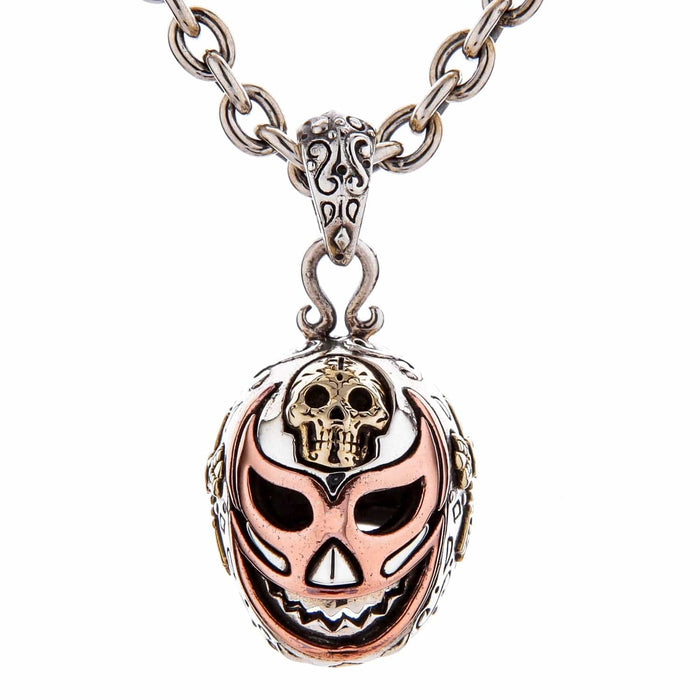 A front view of the tri-color Mexican wrestler mask pendant in silver, brass, and copper.