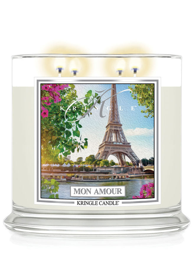 Kringle Candle Mon Amour 4-wick candle lit, with the Eiffel Tower, pretty flowers and the river Seine label.