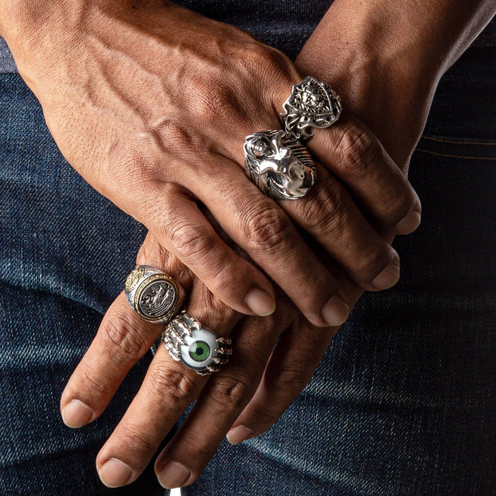 A model's hand wearing the large, artistic nude lady ring to demonstrate its massive and impressive scale.