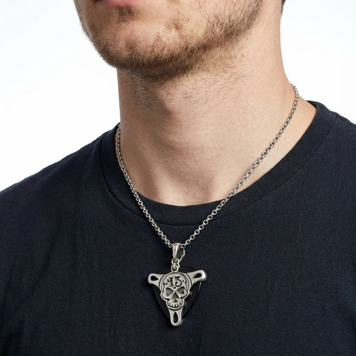 A guitarist wearing the skull pick holder necklace, ready to play.