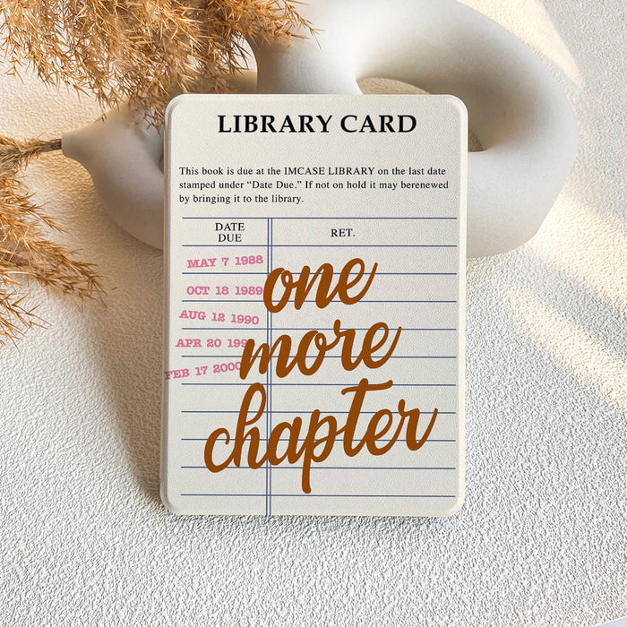 Library card design with 'one more chapter' text on a textured surface