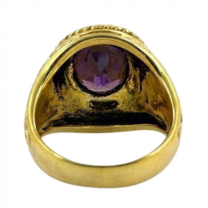 Side view of ornate yellow gold bishop ring showing cross engraving detail and amethyst setting