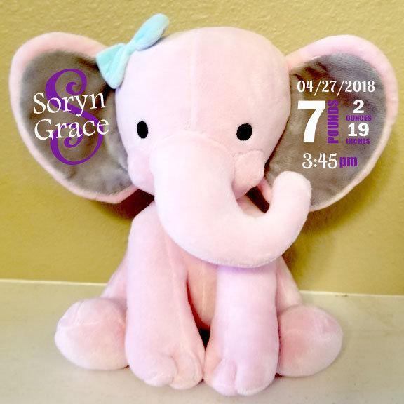 Personalized pink elephant plush used as a birth announcement photo prop