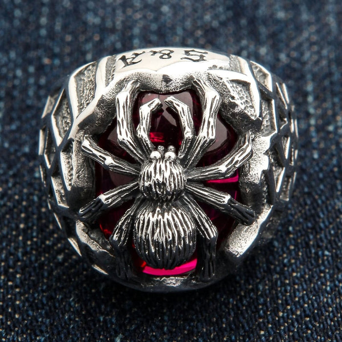 A front view of the sterling silver red stone spider web ring, showing the large faceted gem.