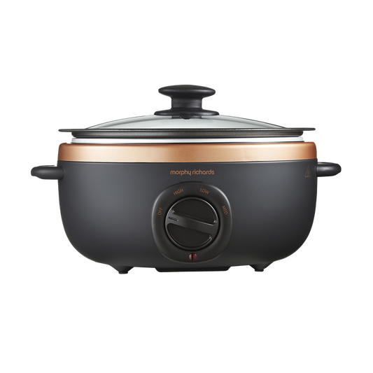 An oval-shaped black and bronze Morphy Richards Sear & Stew Slow Cooker with a glass lid.