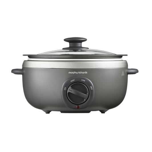 A Morphy Richards Sear & Stew Oval 3.5L Slow Cooker with a transparent glass lid and a grey aluminum cooking pot.