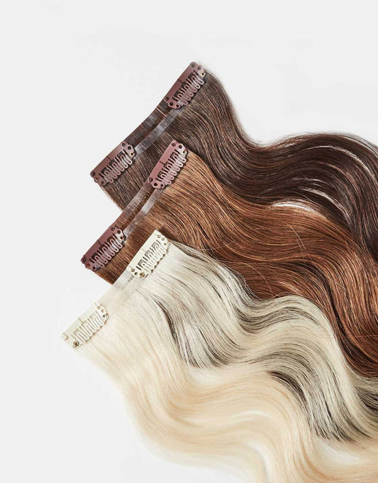 row of bundles of Skinny Clip-In extensions in a variety of colors
