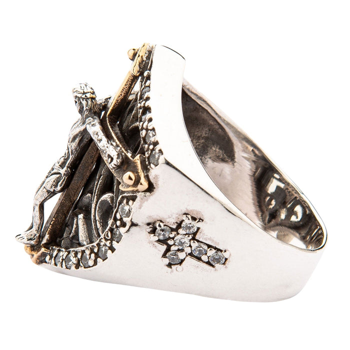The side profile of the crucifix ring, showcasing the small cross on the shank set with clear CZ stones.
