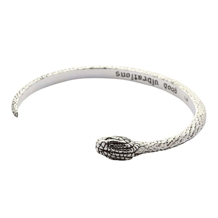 Angled perspective of the snake cuff highlighting the handcrafted scale texture and oxidized finish