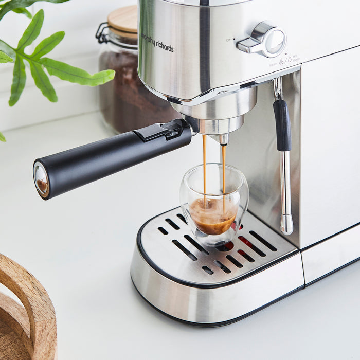 coffee coming out of a coffee machine into a glass