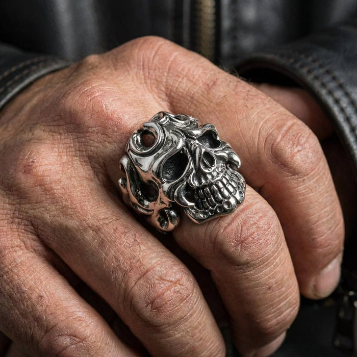 Tribal flame skull ring worn on index finger paired with black leather motorcycle jacket
