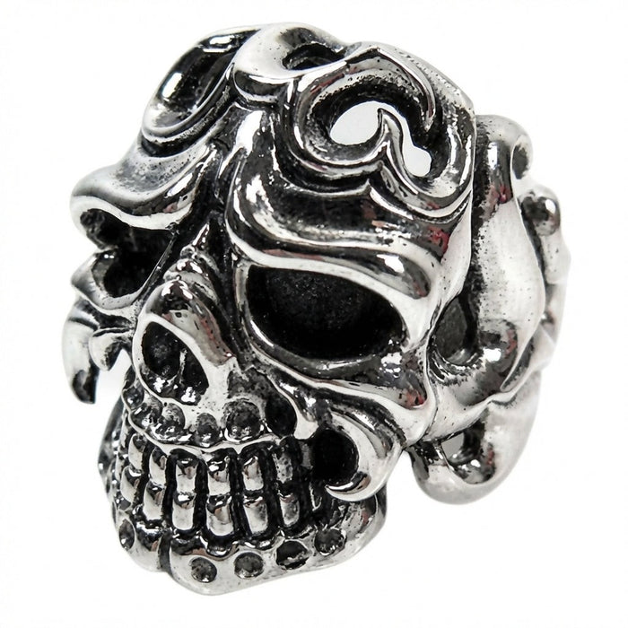 Left side angle of handcrafted skull ring showing swirling tribal flame patterns in oxidized silver