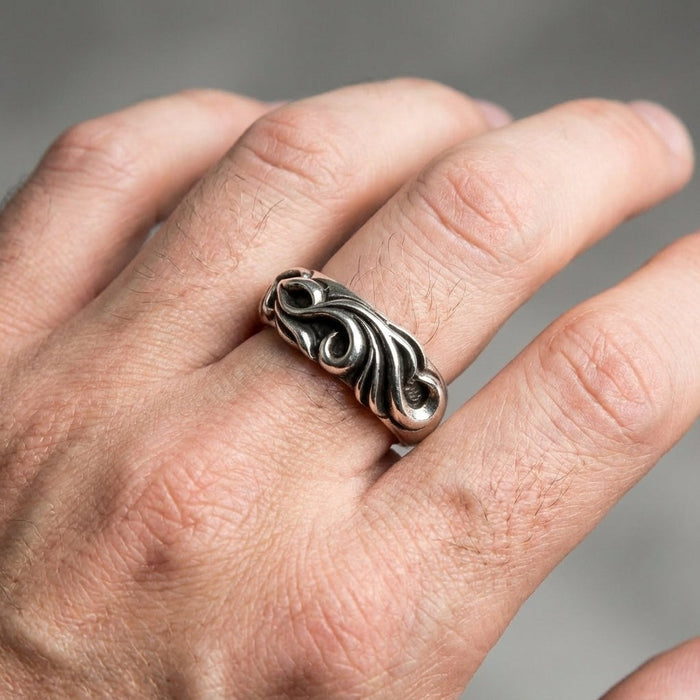 Sterling silver tribal ring worn on man's index finger showing 8mm width