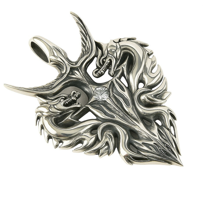 A detailed studio shot of the symmetrical handcrafted silver dragon pendant.