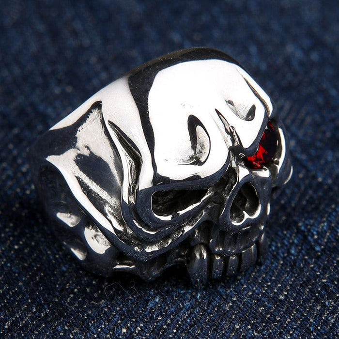 An angled view of the polished vampire skull ring, highlighting the deep red gemstone eye.