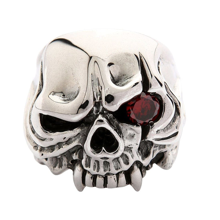 A sterling silver one-eyed vampire skull ring with fangs, isolated on a white background.