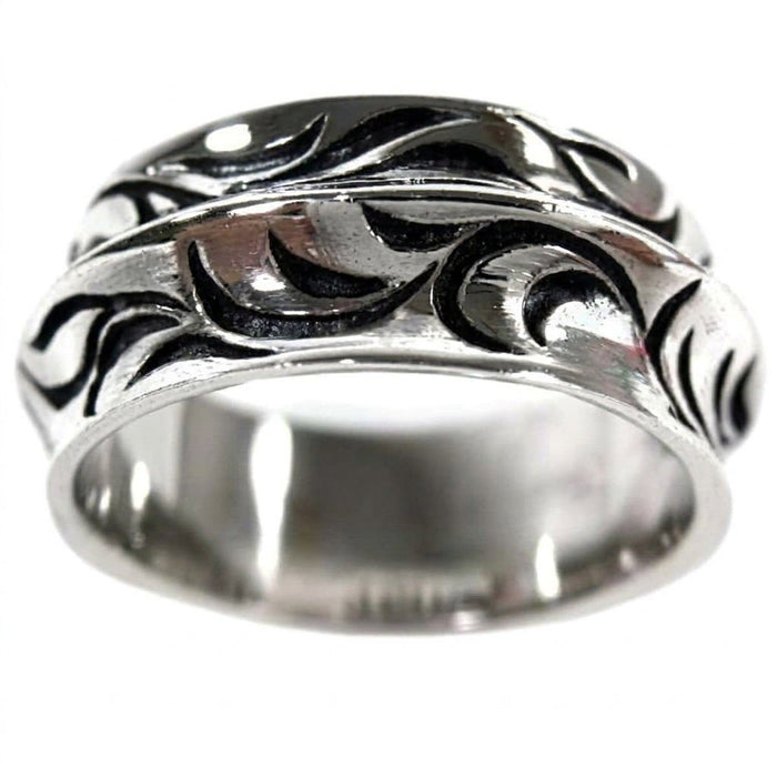 Close-up detail of the dimensional wave carving, contrasting high-shine silver crests with dark shadowed troughs.